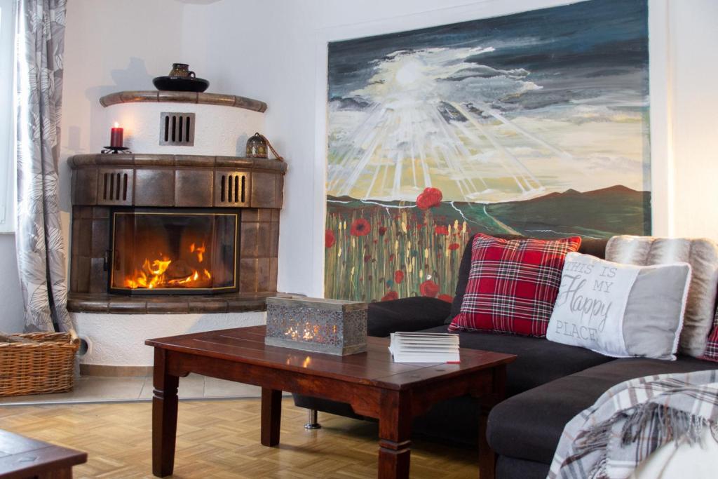 a living room with a couch and a fireplace at Hof Timmermann - Landhaus, unten in Ottenstein