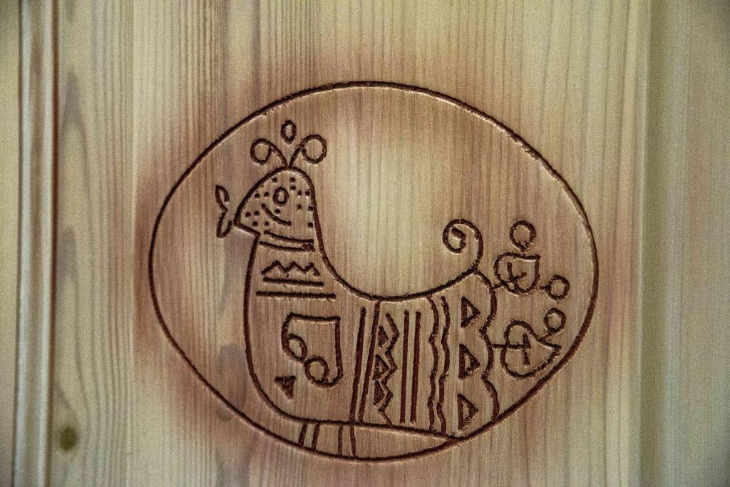 a drawing of a horse on a wooden wall at Hotel L'Oleandro in Villasimius