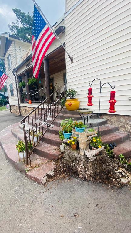 an american flag flying in front of a house at The Summit Inn in Cloudcroft
