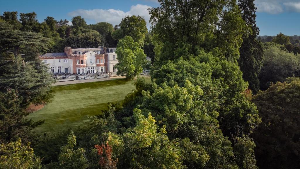 an aerial view of a mansion in the trees at Taplow House Hotel & Spa in Maidenhead