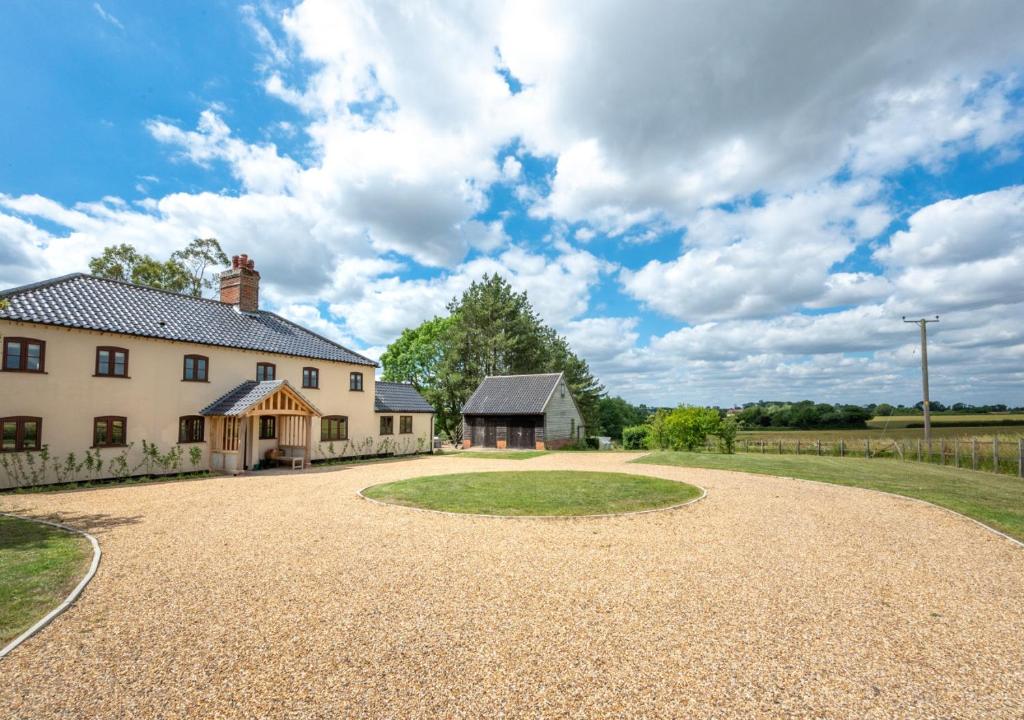 an estate with a large house and a gravel driveway at Fairstead in Spexhall