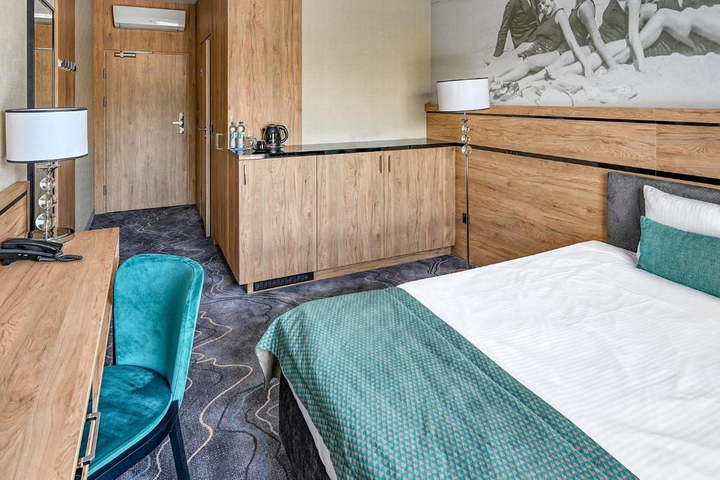 Postel nebo postele na pokoji v ubytování Sopotorium Hotel & Medical Spa