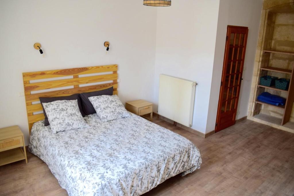 a bedroom with a bed in a room at Chambre d'hôtes Auriac du Périgord in Auriac-du-Périgord