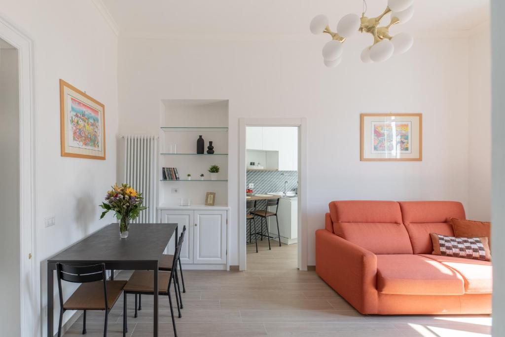 a living room with a orange couch and a table at iFlat Lovely and comfortable flat in Prati in Rome