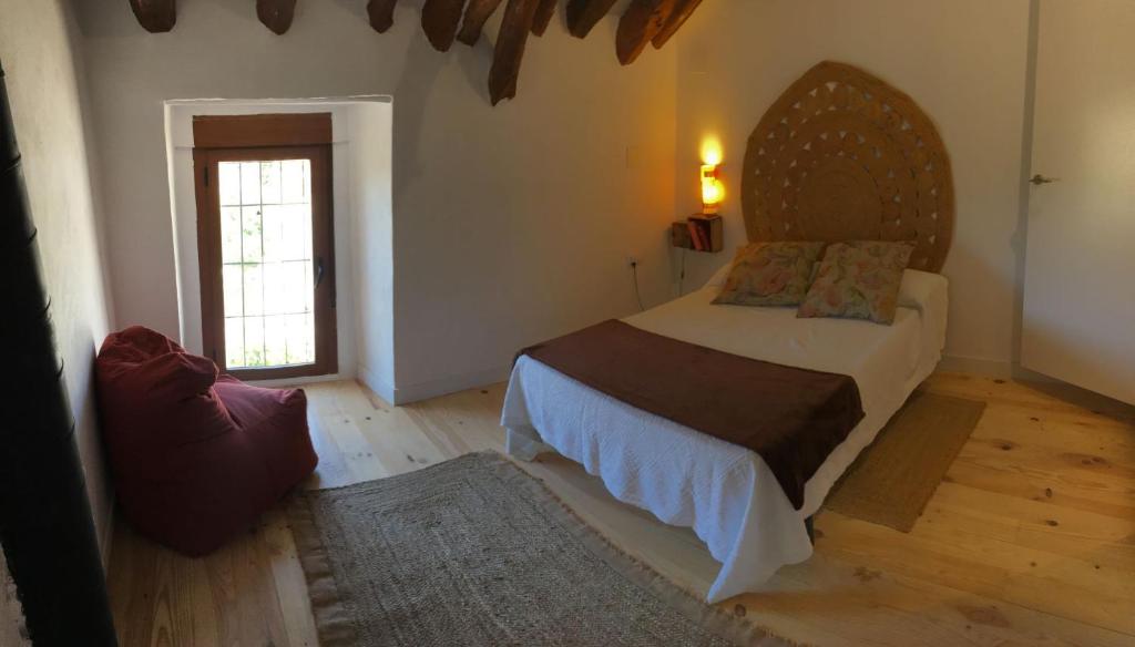 Łóżko lub łóżka w pokoju w obiekcie Casa Montefrio