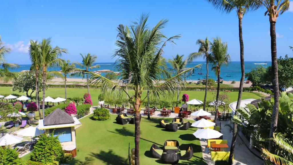 an aerial view of a resort with palm trees and the ocean at Holiday Inn Resort Baruna Bali, an IHG Hotel - CHSE Certified in Kuta