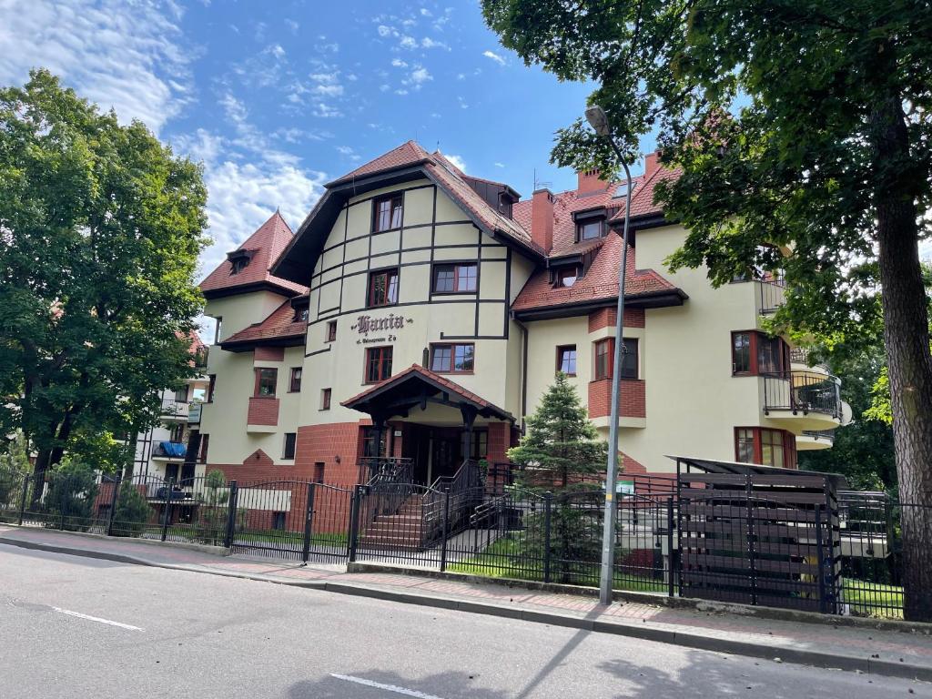 a large house on the side of a street at Apartament Hania - Krynica Morska in Krynica Morska