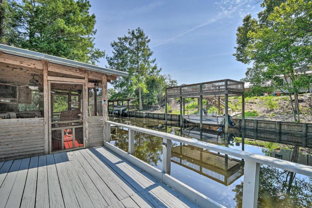 a house on the water with a dock at Peaceful Satsuma Escape with Dunns Creek Access in Satsuma