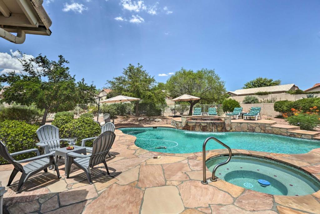 a swimming pool with two chairs and a table and a patioitures at Saddlebrooke Home with Private Pool and Amenities in Catalina