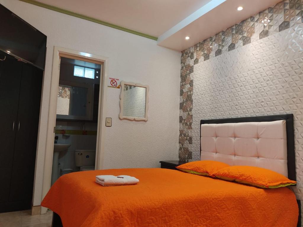 Säng eller sängar i ett rum på Aparta-Hotel El Dorado