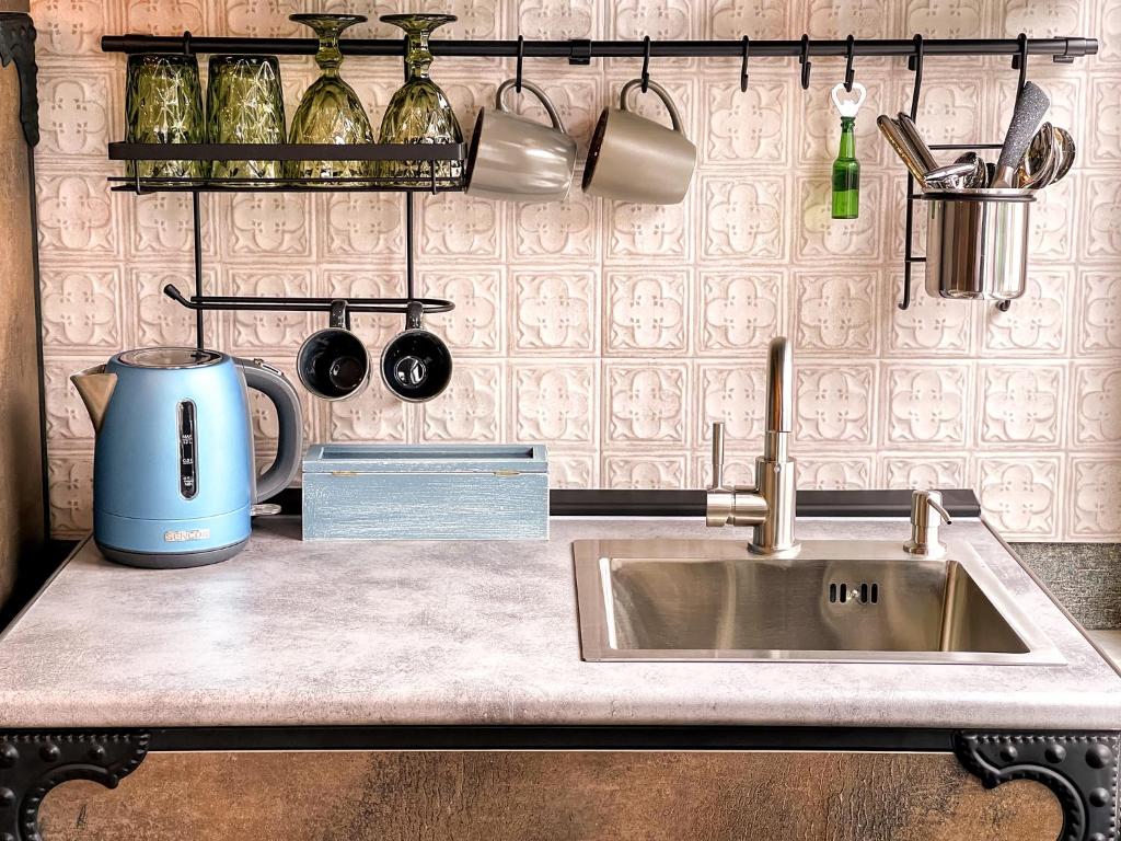 a kitchen counter with a sink and a mixer at 6 Unique Apartments in Tbilisi City