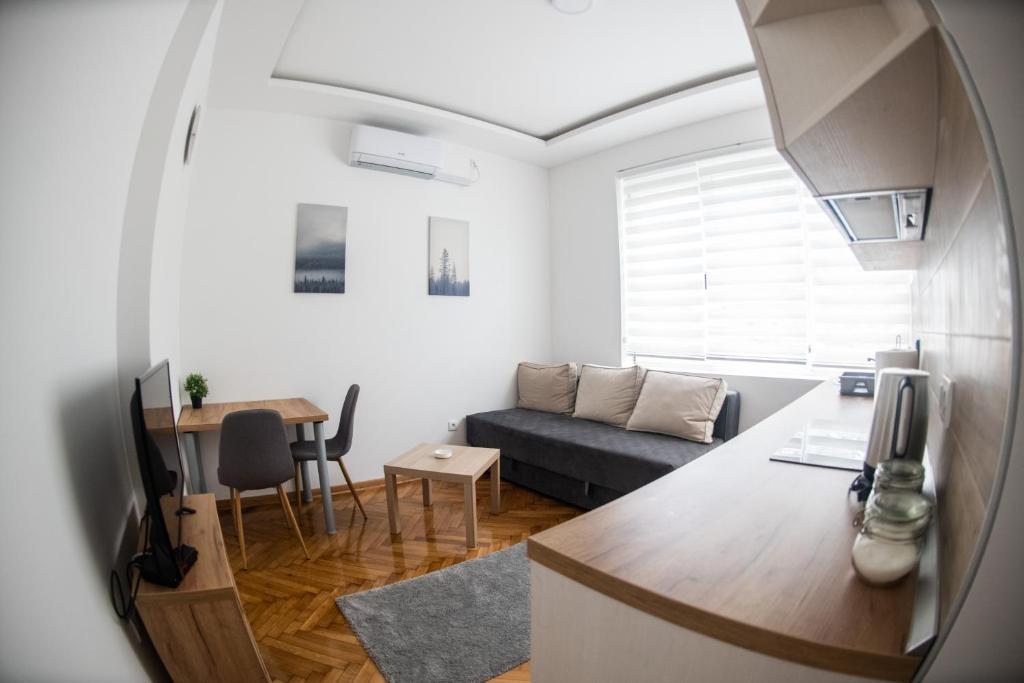 a living room with a couch and a table at APARTMAN TEA 3 in Čukarica