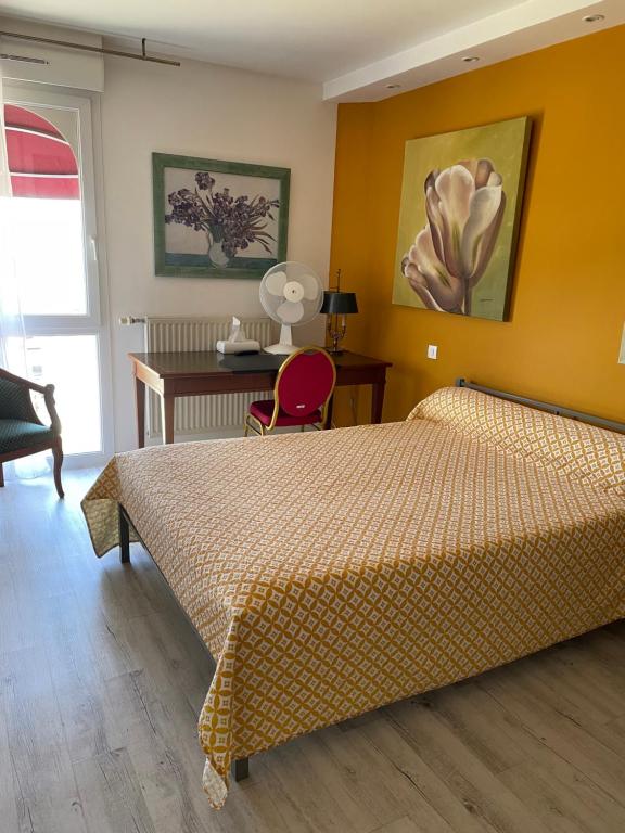 a hotel room with a bed and a desk and a desk at L'Abribis in Firminy