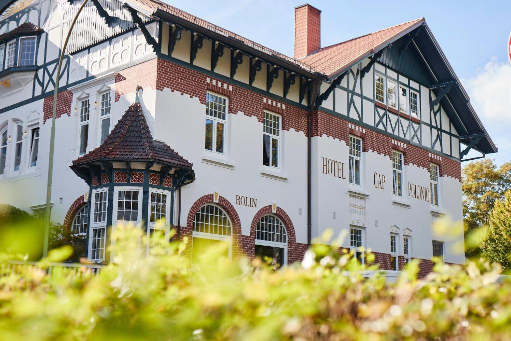 a large brick building with a turret at Hotel Cap Polonio in Pinneberg