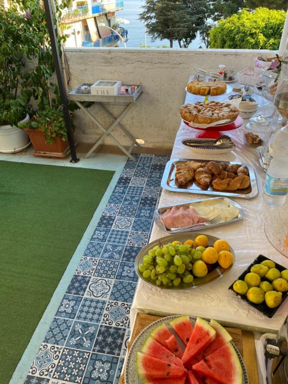 a buffet of food on a table with fruits and vegetables at Hotel Scilla in Scilla