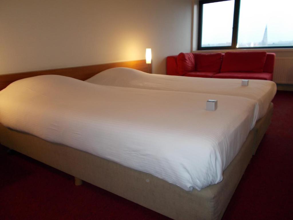 Postel nebo postele na pokoji v ubytování Hotel Corbie Lommel