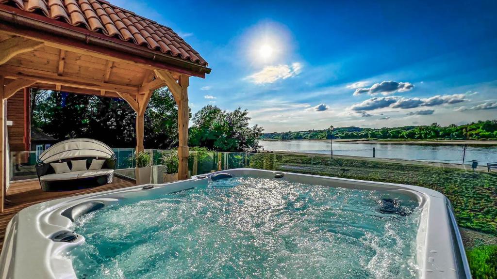 a hot tub in front of a gazebo at Bulwar Residence & Wellness in Kazimierz Dolny