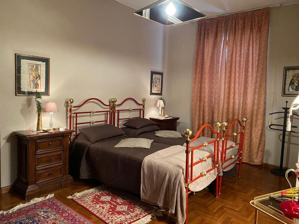 a bedroom with a bed and a dresser and curtains at Bice house in Terni