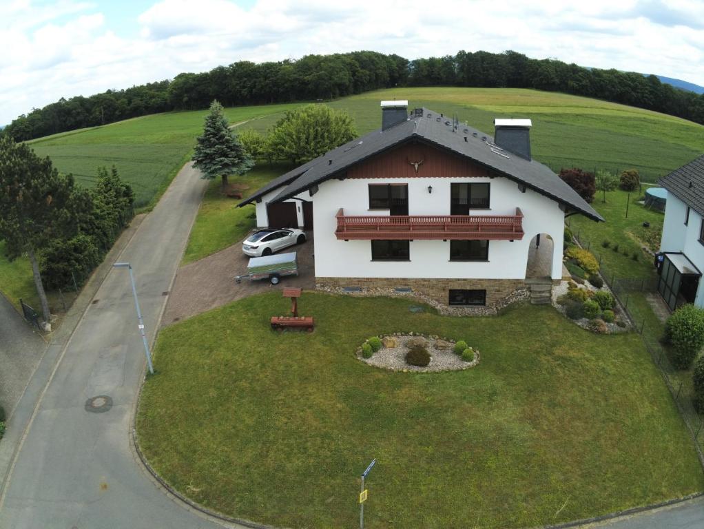 a house with a bench on top of a yard at Idyllisches Ferienhaus “Werra Ausblick” am Meißner in Hitzerode