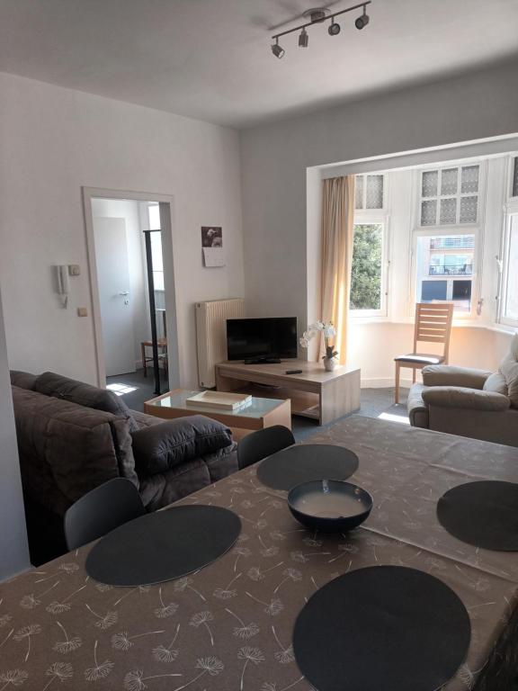 a living room with a couch and a table at Apartment Descamps in Blankenberge