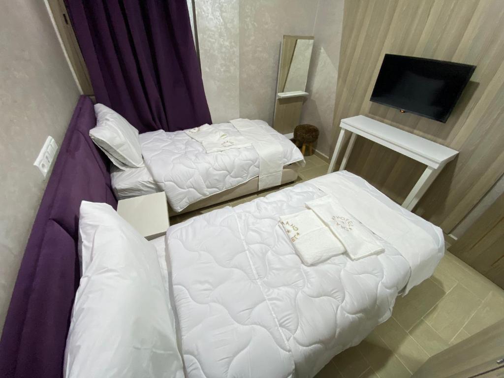 Postel nebo postele na pokoji v ubytování Hôtel Chark