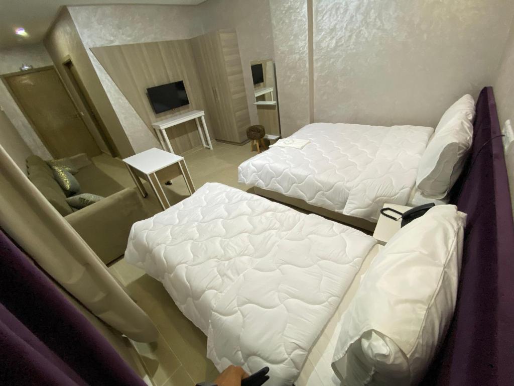 Postel nebo postele na pokoji v ubytování Hôtel Chark