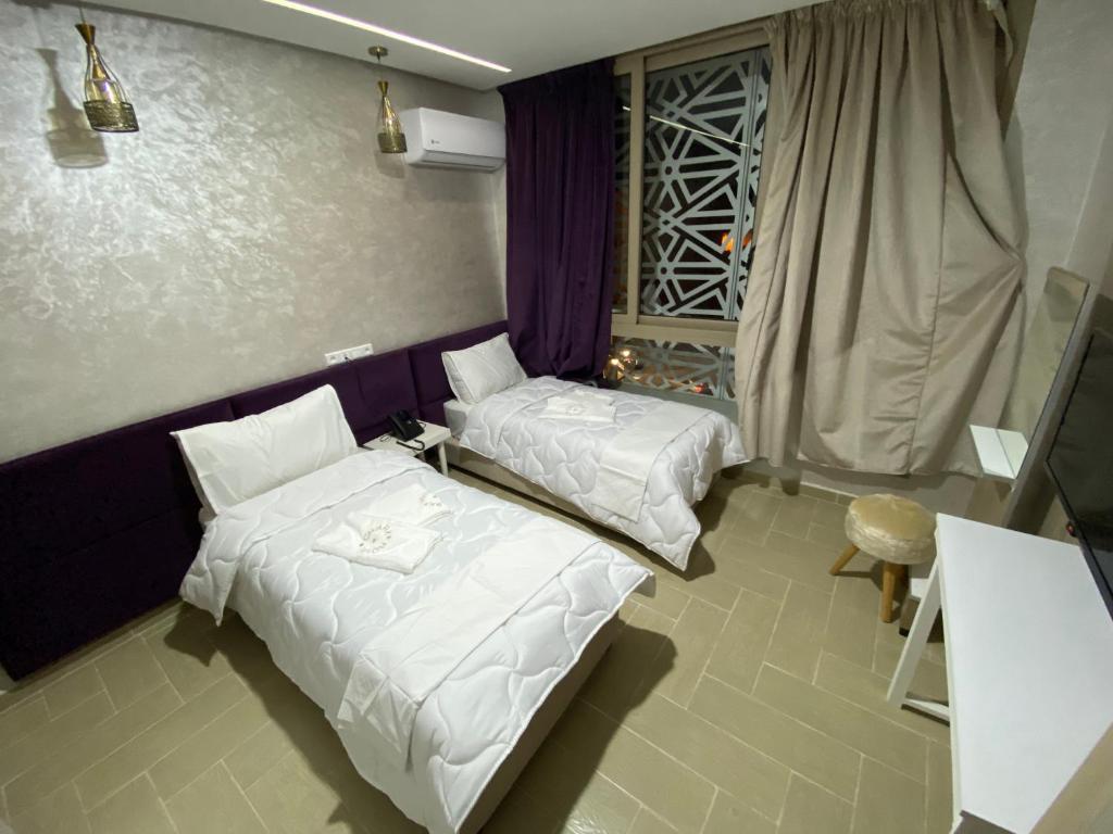 Postel nebo postele na pokoji v ubytování Hôtel Chark