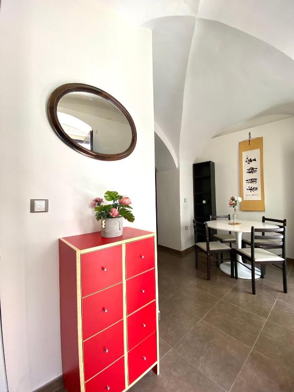 a room with a red dresser and a table with a mirror at La bodeguita 1 in Zafra