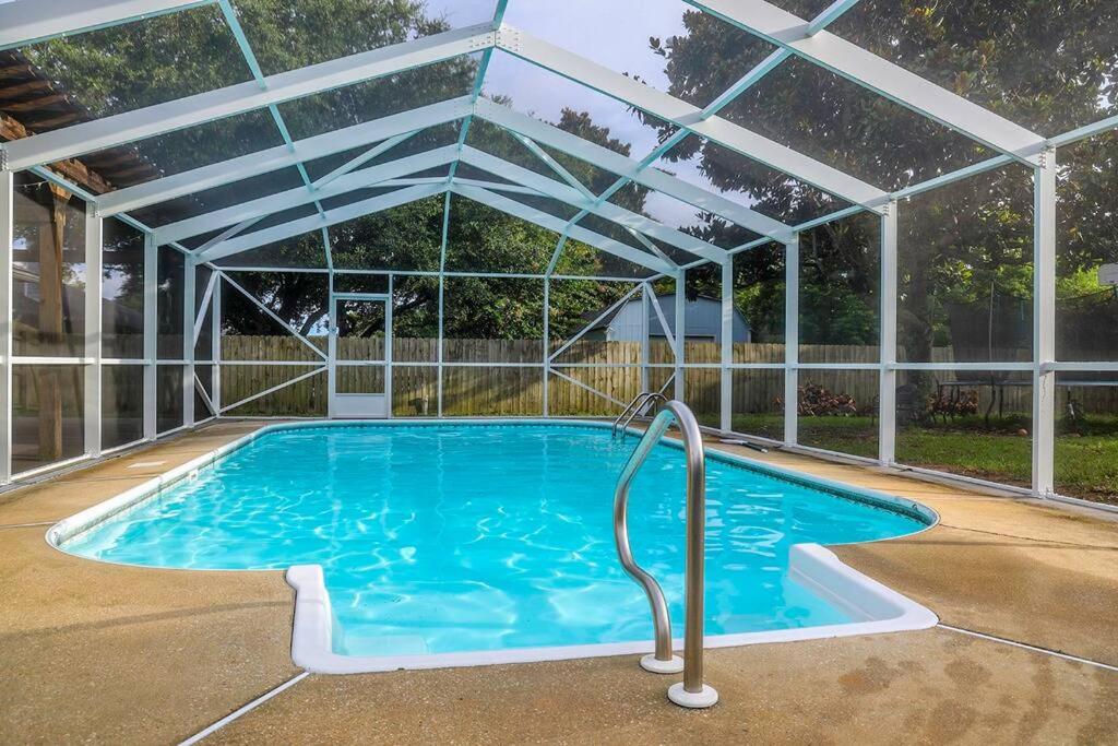 a swimming pool with a clear plastic roof over it at Pool House, Short Drive to Beach, Grill, Smart TV in Navarre