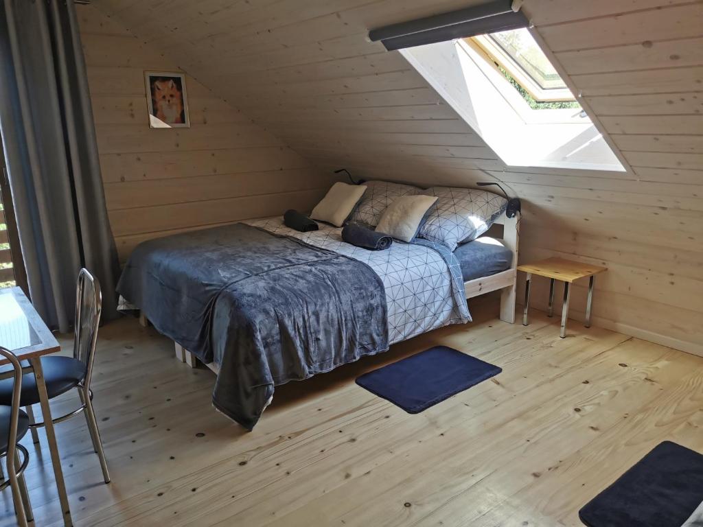 a bedroom with a bed in a attic at Noclegi Świętokrzyskie w Dolinie Wilkowskiej,, Pod Jeleniami "prawdziwymi in Święta Katarzyna