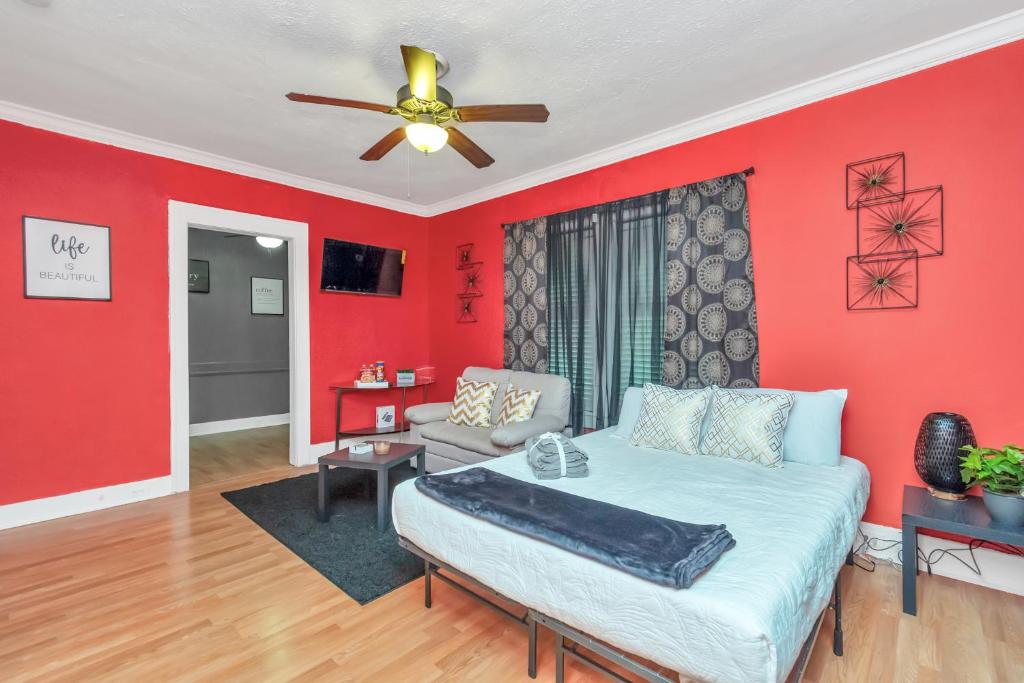 a living room with red walls and a couch at Calm Cozy Oasis in the Heart of Houston by Toyota Center in Houston
