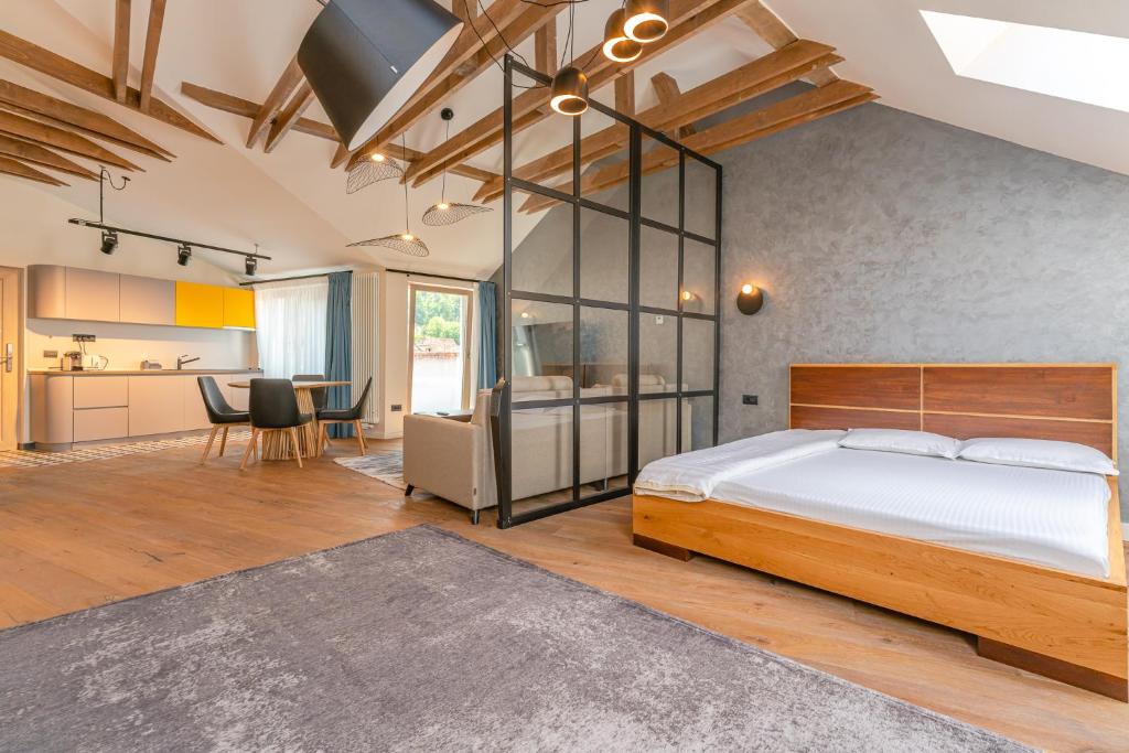 a bedroom with a large bed and a kitchen at premium suites Postavarului in Braşov
