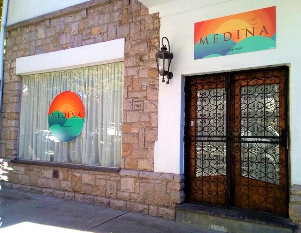 a building with a window with a sign on it at Hotel Medina B&B in Mar del Plata