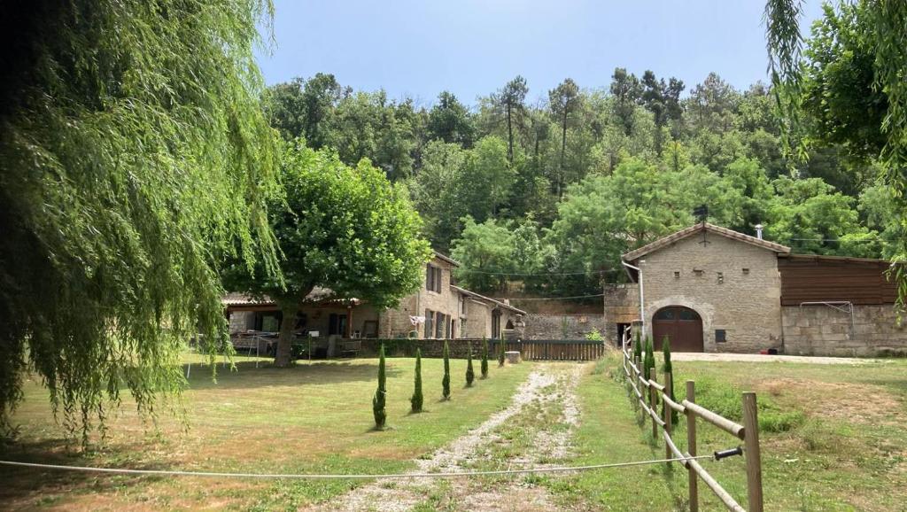 Claveyson的住宿－Gite Equestre Drôme des Collines，一座农场,有栅栏,有一座建筑和树木