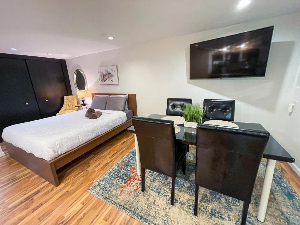 a bedroom with a bed and a desk with a table at Wrigley Garden Unit in Chicago