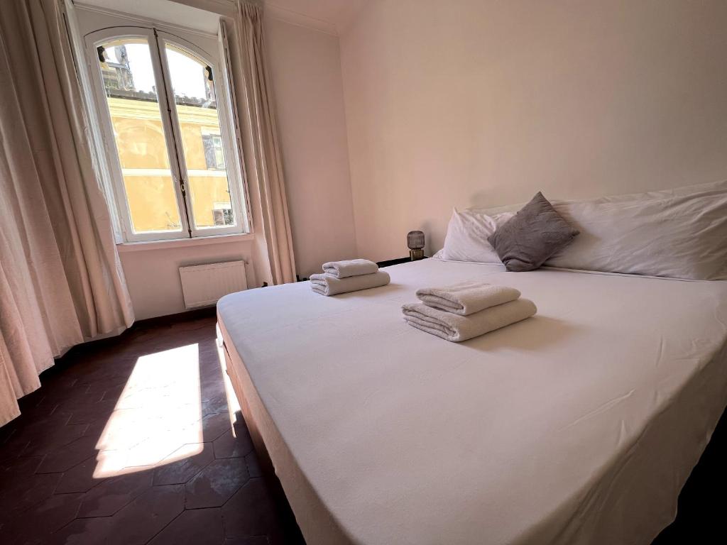 a bedroom with a large white bed with towels on it at Rome city center in Rome