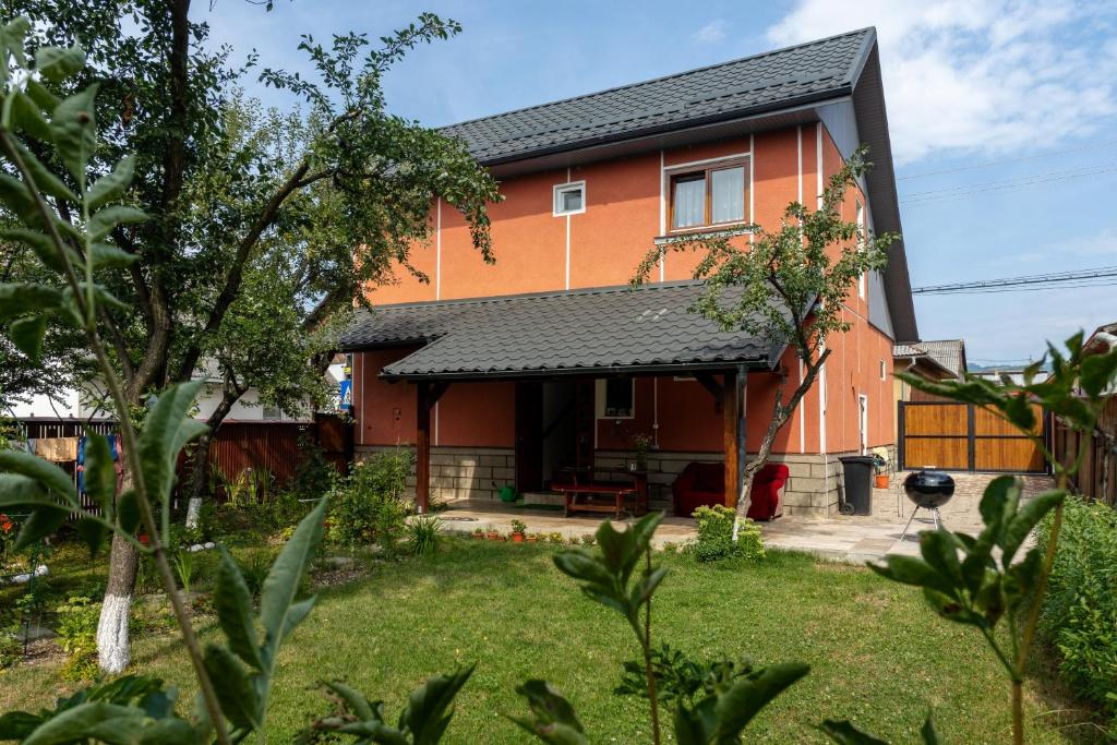 a orange house with a black roof at Generous family home in Vişeu de Sus