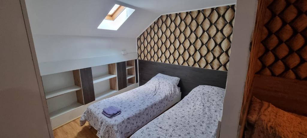 a small room with two beds in it at Sobe Royal Apartman in Šabac