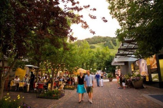 a group of people walking down a brick street at Downtown Aspen 2 Bedroom Condo in Aspen