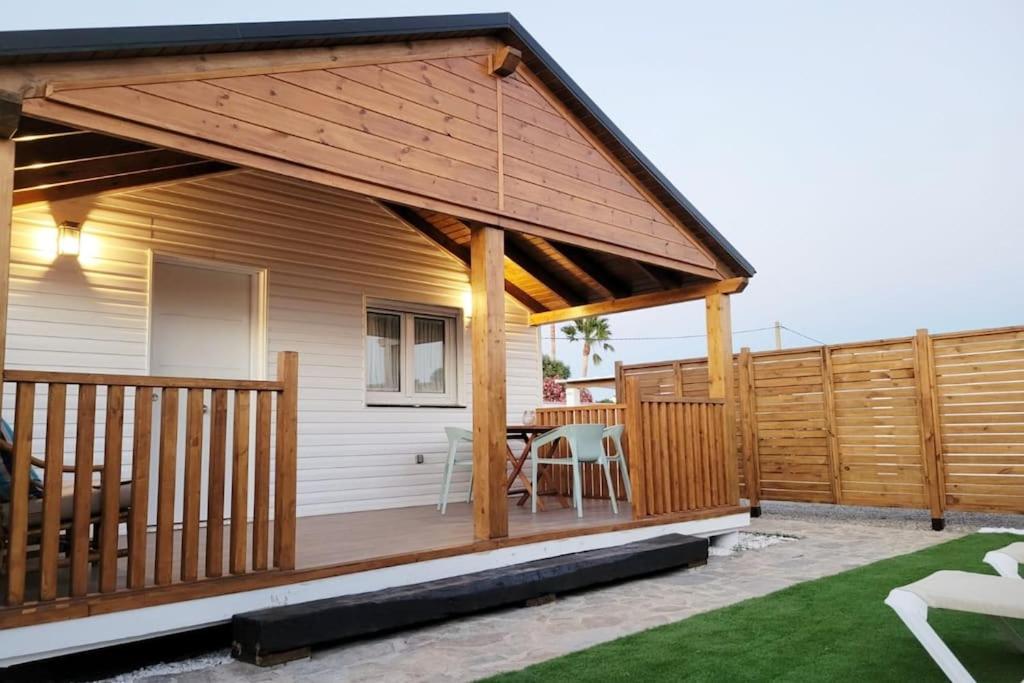 a wooden deck with a pavilion on a house at Casa Nordica cerca del mar in El Palmar