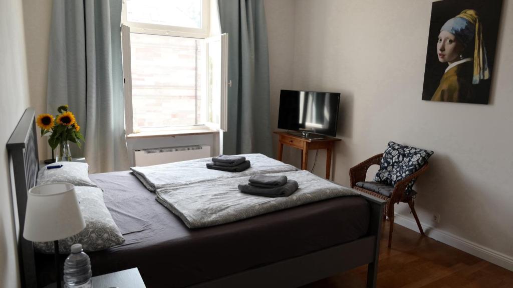 a bedroom with a bed and a painting of a woman at Haus am Seerhein in Konstanz