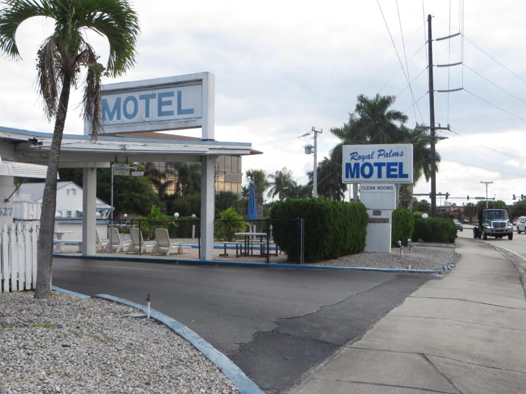 a mobil station with a palm tree and a motel at Royal Palms Motel in Stuart