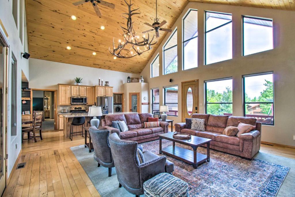 a living room with a couch and a table at Hot Tub and Game Room All-Season Pinetop Cabin in Pinetop-Lakeside