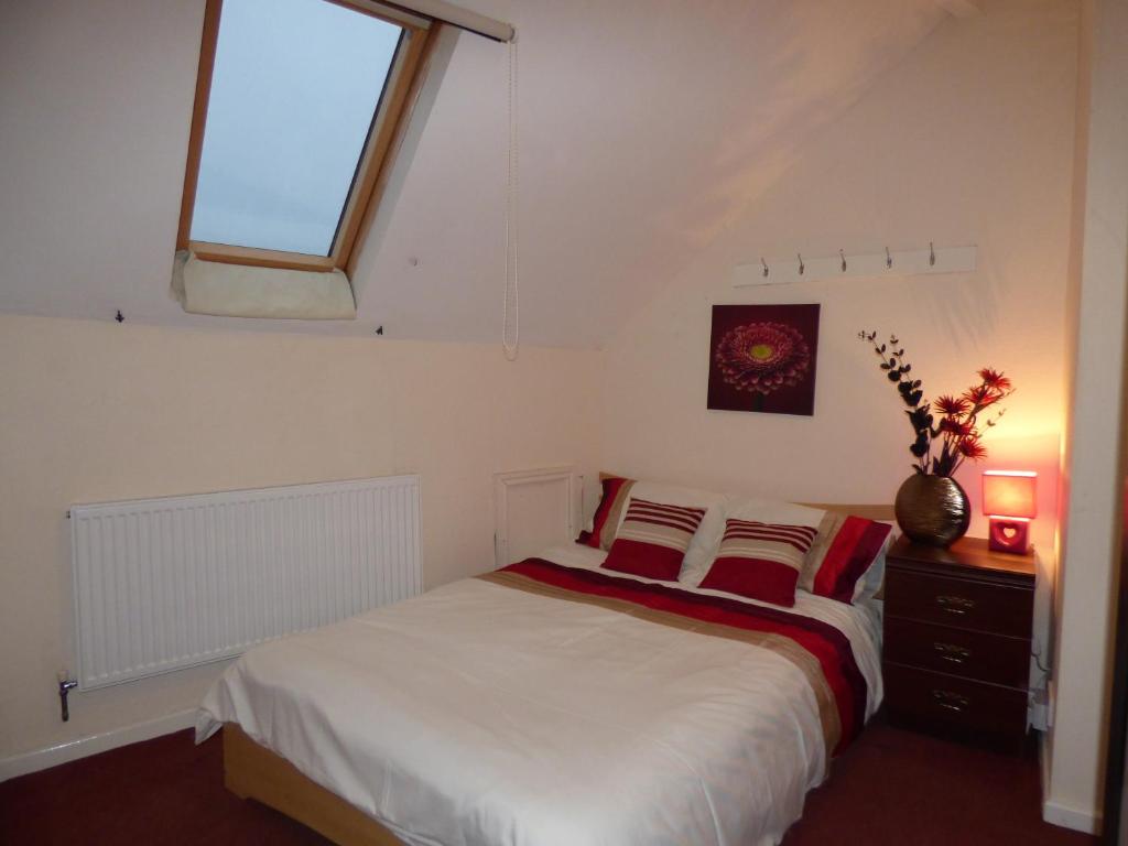 a bedroom with a bed and a window in it at Station House in Shirebrook