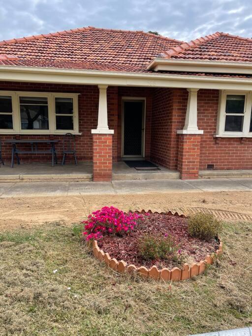 a house with a flower bed in front of it at Classic Beauty in Albury