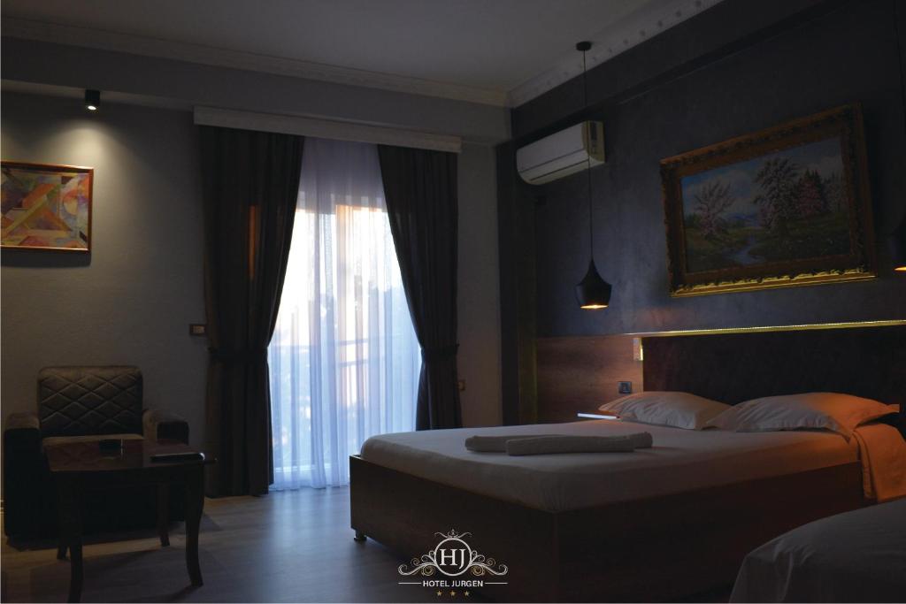 a bedroom with a large bed and a window at Hotel Jurgen in Lezhë