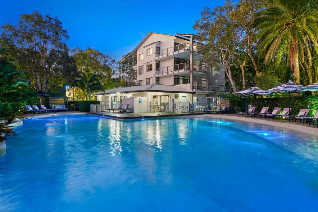 a large swimming pool in front of a building at Club Wyndham Flynns Beach, Trademark Collection by Wyndham in Port Macquarie