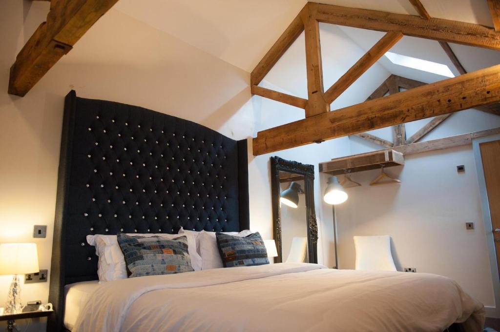 a bedroom with a large bed and wooden beams at Hotel Forty One in Great Driffield