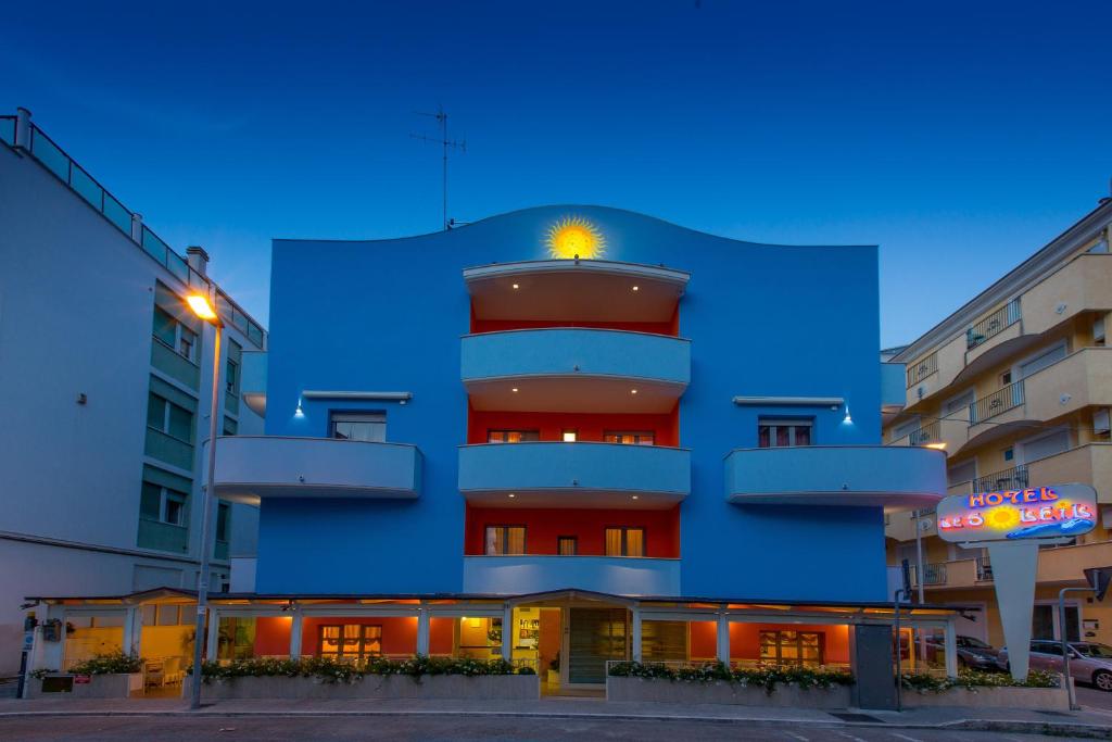 a blue building with a sign in front of it at Hotel Le Soleil in San Benedetto del Tronto