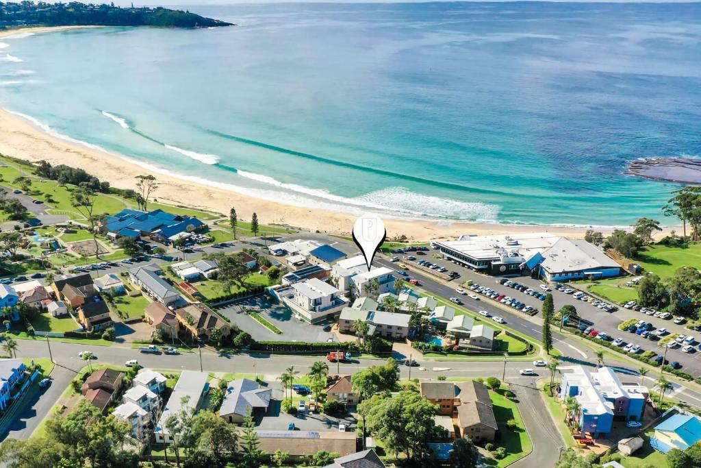 an aerial view of a town next to the beach at Beachfront Five in Mollymook